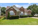 Inviting brick home with neat landscaping, arched windows, and a well-kept lawn at 5508 Burning Ridge Dr, Monroe, NC 28110
