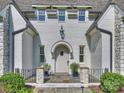Charming front entrance featuring a stone pathway, gray painted brick, and decorative plantings at 6314 Saint Stephen Ln, Charlotte, NC 28210