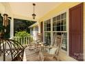 Cozy front porch with rocking chairs, decorative pillows, and hanging lantern at 637 Freemont Dr, Lancaster, SC 29720