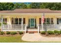 Inviting front porch with white railings, shutters, and a blue front door at 637 Freemont Dr, Lancaster, SC 29720