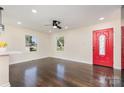 Inviting living room with hardwood floors, bright windows, and a vibrant red front door at 803 Irene Ave, Kannapolis, NC 28083