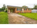 Exterior view of a brick home with covered carport and concrete driveway at 1019 Carmel Dr, Gastonia, NC 28056