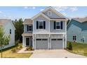 Charming two-story home featuring a two-car garage, light blue siding and a welcoming entrance at 11195 Argosy Dr # 1098, Lancaster, SC 29720