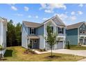 Charming two-story home featuring a two-car garage, light blue siding, manicured lawn and welcoming entrance at 11195 Argosy Dr # 1098, Lancaster, SC 29720