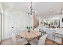 Bright dining area features modern lighting, table and chairs, and white walls at 1223 E 16Th St # 13, Charlotte, NC 28205