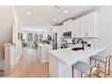 Modern kitchen with white cabinets, stainless steel appliances, and a breakfast bar at 1223 E 16Th St # 13, Charlotte, NC 28205