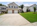 Exterior view of a two-story townhome with a two-car garage and well-kept lawn at 12415 Stratfield Place Cir, Pineville, NC 28134