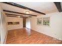 Bright living area with hardwood floors, exposed beam ceiling, and ample natural light at 1409 Turner Dr, Gastonia, NC 28052