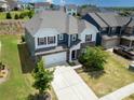 Aerial view of a charming home with well-manicured lawn and driveway nestled within a lovely neighborhood at 15119 Oleander Dr, Charlotte, NC 28278