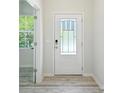 Bright entryway featuring a stylish front door with glass panels and durable hardwood flooring at 15119 Oleander Dr, Charlotte, NC 28278