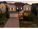 Charming two-story home with stone accents, landscaped yard, and an attached two-car garage at 15119 Oleander Dr, Charlotte, NC 28278