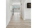 Bright hallway with wood floors leading to the living room with large windows and natural light at 15119 Oleander Dr, Charlotte, NC 28278