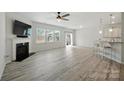 Spacious living room with fireplace, bright windows, and an open floor plan leading to the kitchen at 15119 Oleander Dr, Charlotte, NC 28278