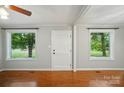 Bright living room features hardwood floors, fresh gray paint, and windows framing views of the landscaped exterior at 1535 Maplewood Ave, Lancaster, SC 29720