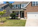 Lovely home featuring brick and gray siding, well-maintained landscaping, covered porch, and a convenient two-car garage at 169 Rooster Tail Ln, Troutman, NC 28166