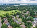 Aerial view of the neighborhood, showcasing its lush greenery, lakeside views, and golf course at 19205 Hidden Cove Ln, Cornelius, NC 28031