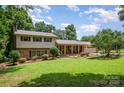 Charming two-story home with brick accents, mature landscaping, and a covered porch in a beautiful, serene setting at 2109 Quail Nw Dr, Concord, NC 28027