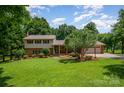 Charming two-story home with brick accents, mature landscaping, and a two-car garage in a beautiful, serene setting at 2109 Quail Nw Dr, Concord, NC 28027