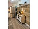 Well-equipped kitchen with stainless steel refrigerator, a built-in beverage cooler, and a wood accent wall at 2109 Quail Nw Dr, Concord, NC 28027