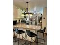 Bright kitchen with light countertops, a breakfast bar with seating, stainless steel appliances, and ample counter space at 2109 Quail Nw Dr, Concord, NC 28027