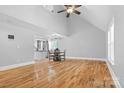 Open-concept living area featuring hardwood floors, high ceilings, and an adjacent kitchen at 220 Plonk Rd, Dallas, NC 28034