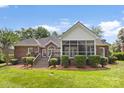 A brick home with a screened in porch and deck with manicured shrubbery at 2241 Flagstick Dr, Matthews, NC 28104