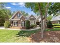 Beautiful brick home with a well-manicured lawn and lush, mature landscaping at 2241 Flagstick Dr, Matthews, NC 28104