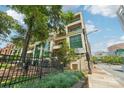 Apartment building featuring multiple balconies and lush greenery at 229 N Church St # 401, Charlotte, NC 28202