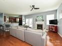 Spacious living room with a fireplace, ceiling fan, and an open view of the kitchen at 3009 Canopy Dr, Indian Trail, NC 28079