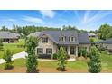 Beautiful home with landscaped yard, brick facade, dormer windows, and a gray shingle roof at 3256 Fairmead Dr, Concord, NC 28025