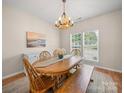 Bright dining room featuring a wooden table, matching chairs and bench, and ample natural light at 3301 Old Knobbley Oak Dr, Gastonia, NC 28056