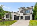 Beautiful modern home featuring two car garage, black framed windows, balcony and manicured lawn in daytime against a bright sky at 3308 Carmel Rd, Charlotte, NC 28226