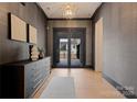 Beautiful foyer features hardwood floors, gray textured walls, and a stylish console table with decorative items at 3308 Carmel Rd, Charlotte, NC 28226