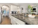 Kitchen island with double sink and granite countertop open to dining area at 3332 Katherine Taylor Ct, Monroe, NC 28110
