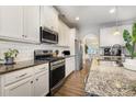 Modern kitchen with granite countertops, subway tile backsplash, and stainless steel appliances at 3332 Katherine Taylor Ct, Monroe, NC 28110