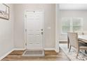 Bright entryway with wood floors, a front door, and a view into the dining area at 4014 Stockbrook Dr, Charlotte, NC 28215