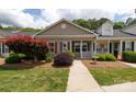 Inviting home exterior featuring manicured landscaping and a charming covered porch at 409 Guiness Pl, Rock Hill, SC 29730