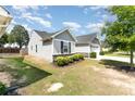 A shot of the side of two light gray single-story houses with well-kept lawns at 4227 Mackinnon Dr, Charlotte, NC 28214
