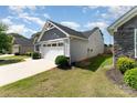 A lovely single-story home with a two-car garage, adjacent to a well-maintained lawn at 4227 Mackinnon Dr, Charlotte, NC 28214
