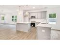 Modern kitchen featuring stainless steel appliances, a subway tile backsplash, and an island at 5185 Grand Canyon Rd, Concord, NC 28027