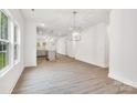 Bright and airy living room with hardwood floors and views into the kitchen area at 5185 Grand Canyon Rd, Concord, NC 28027