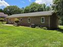 Landscaped backyard with mature trees and green lawn providing privacy at 5238 Bethel Church Rd, Hickory, NC 28602