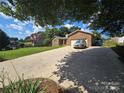 View of a well-maintained brick home with an attached garage and long driveway at 5238 Bethel Church Rd, Hickory, NC 28602