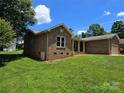 Lovely home with brick facade, green lawn, mature trees, and white trim windows at 5238 Bethel Church Rd, Hickory, NC 28602