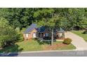 Lovely single-story brick home featuring a large front yard, mature trees, and a welcoming walkway at 600 Queens Rd, Cherryville, NC 28021