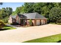Spacious three-car garage with an expansive driveway and manicured lawn, creating a welcoming approach at 600 Queens Rd, Cherryville, NC 28021