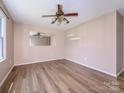 Spacious bedroom with a ceiling fan and stylish laminate flooring at 618 Springfield Nw Dr, Concord, NC 28027