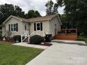 Well-maintained home featuring a lovely deck, manicured lawn, and convenient paved driveway at 618 Springfield Nw Dr, Concord, NC 28027