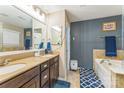 Well-lit bathroom featuring a double vanity, a soaking tub, and tasteful tile accents at 6412 Bluegill Rd, Charlotte, NC 28216