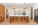Bright kitchen with a large island and seating, modern appliances, and open shelving at 6711 Creft Cir, Lake Park, NC 28079